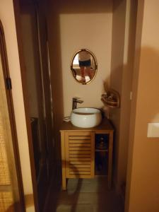 a bathroom with a sink and a mirror at Le Logis Rabelaisien in Bourgueil