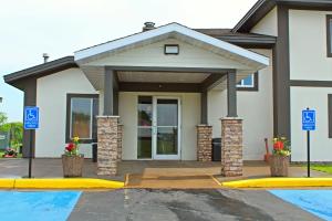 a house with two blue signs in front of it at Days Inn by Wyndham West-Eau Claire in Eau Claire