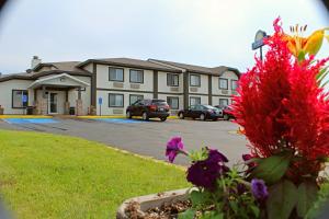 a large building with cars parked in a parking lot at Days Inn by Wyndham West-Eau Claire in Eau Claire