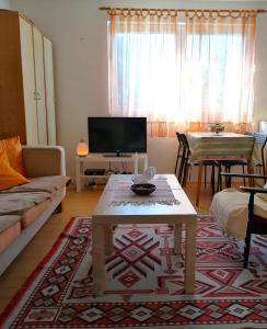 a living room with a couch and a coffee table at Villa Lila in Dolno Dupeni