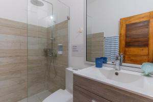 a bathroom with a white sink and a shower at Villa Palacio Verde Las terrenas in Las Terrenas +23 photos