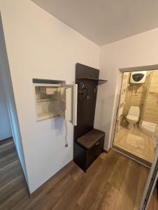 a small bathroom with a toilet and a sink at La Moară la Făgădău in Tuşnad