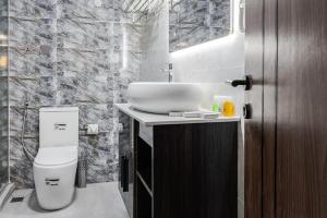 a bathroom with a sink and a toilet at BON Hotel Emporium in Ughelli