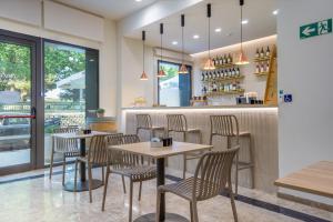 Ein Restaurant mit Tischen und Stühlen vor einer Theke in der Unterkunft Checkin Valencia Ciscar in Picanya