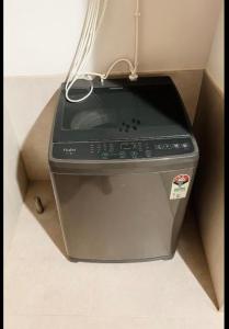 a electronic device sitting on the floor in a corner at Gayathri Residency premium 2bhk in Hyderabad +3 photos