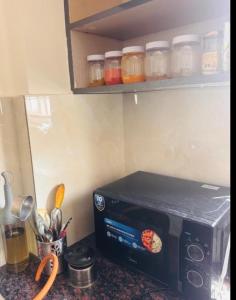 a microwave sitting on a counter in a kitchen at Gayathri Residency premium 2bhk in Hyderabad