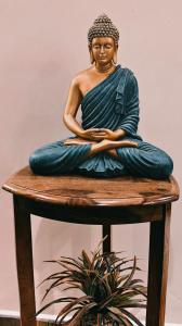 a statue of a woman sitting on a stool at MKR GRANd in Rāmeswaram