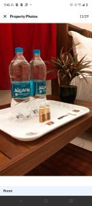 two bottles of water sitting on top of a table at MKR GRANd in Rāmeswaram +8 photos