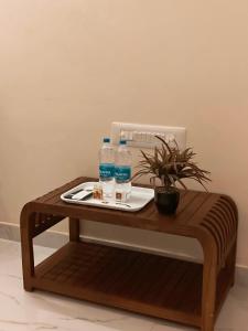a wooden table with two bottles of water on it at MKR GRANd in Rāmeswaram