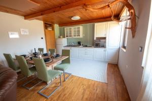 a kitchen and dining room with a table and chairs at Kopitnik cosy cabin in Dol pri Hrastniku