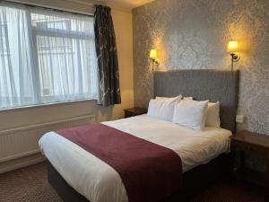 a hotel room with a large bed with a large window at Ye Olde Talbot Hotel by Greene King Inns in Worcester