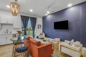 a living room with a couch and a tv at Tiger Lily in Nashville