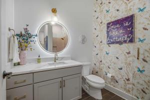 a bathroom with a sink and a mirror and a toilet at Tiger Lily in Nashville
