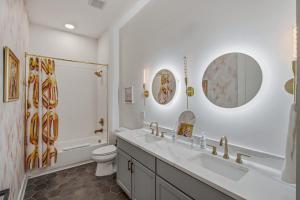 a bathroom with two sinks and a toilet and a shower at Tiger Lily in Nashville +8 photos