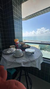 a table with food on it with a view of the ocean at Summer house in Olinda