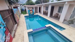 a large blue swimming pool next to a house at Casa Troya in Nueva Gorgona