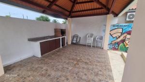 a room with a kitchen and a painting on the wall at Casa Troya in Nueva Gorgona