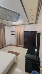 a bedroom with a bed and a desk in it at السلطان هاوس in Najran +3 photos