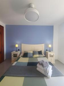a bedroom with a bed and two night stands and two lamps at Duplex Beach Cabezo 2h terrace in El Médano