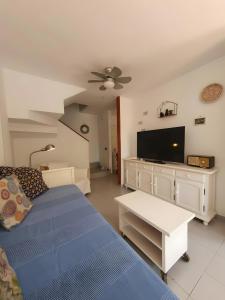 a bedroom with a bed and a flat screen tv at Duplex Beach Cabezo 2h terrace in El Médano