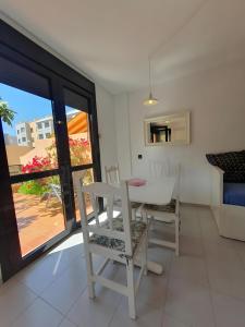 a dining room with a white table and chairs at Duplex Beach Cabezo 2h terrace in El Médano