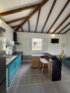 a kitchen with blue cabinets and a table at Freedom House in Le Diamant
