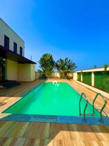 a swimming pool in the middle of a house at Maxi villa maamalla in Mahabalipuram