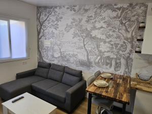 a living room with a couch and a table at O Alpendre in Bueu