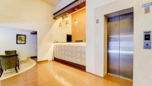 a hallway with a large metal door in a building at Hotel Holiday Park,Thalassery in Green Island