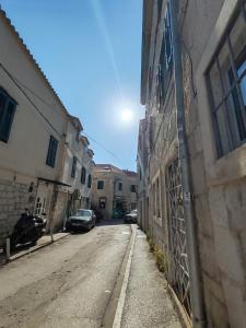 an empty street in an alley between two buildings at Inspiration room - Toć in Split