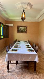 a large dining room with a large table with chairs at Villa Riad Ambre in Douar bel Rhanodour