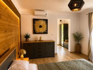 a bedroom with a bed and a dresser with a mirror at Villa Franca Luxury Chalets in Sighişoara
