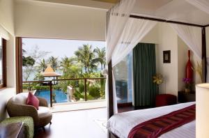 a bedroom with a bed and a view of the ocean at Dhevatara Cove in Lipa Noi +100 photos