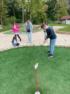 a group of people playing a game of golf at Villa Franca Luxury Chalets in Sighişoara