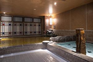 a room with a pool of water in a building at Dormy Inn Kobe Motomachi Natural Hot Springs in Kobe