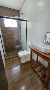 a bathroom with a sink and a toilet at Suítes Ninho dos Lobos in Pardinho +7 photos