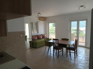 a living room with a table and chairs and a couch at Kumbor S in Herceg-Novi +6 photos