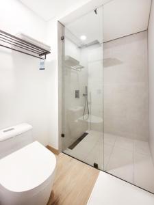a bathroom with a toilet and a shower at Blues Suites Laureles in Medellín +21 photos