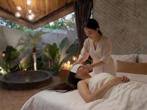 a woman in a spa giving a woman a massage at Award-Winning 3BR Villa 25m Pool Villa FEH in Kerobokan