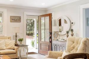 a living room with a door and a mirror at Pigeon Point Cottage with State Park Beach Pass in Beaufort