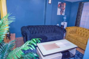 a living room with a couch and a table at Micasa Homes BNB GF in Limuru