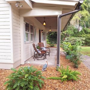 a porch of a house with two birds on it at Pigeon Point Cottage with State Park Beach Pass in Beaufort