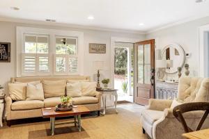 a living room with a couch and a table at Pigeon Point Cottage with State Park Beach Pass in Beaufort +33 photos