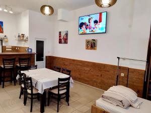 a dining room with a white table and chairs at Apartments Alexandra in Pleven