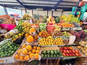 a market filled with lots of different fruits and vegetables at Suite Tarqui en el Centro Histórico in Cuenca
