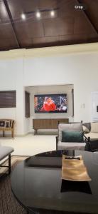 a living room with a flat screen tv on a wall at The Villa at Mertolas in Alitagtag