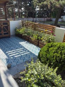 a garden with a wooden bench and some plants at Apartmán Větrná s klimatizací a terasou in Zlín