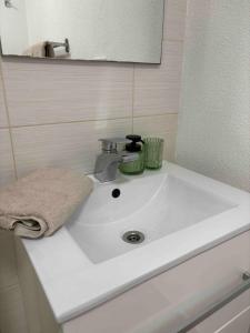 a white sink in a bathroom with a mirror at Apartmán Větrná s klimatizací a terasou in Zlín