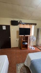 a bedroom with a flat screen tv on the wall at Accommodation #6 in Copán Ruinas in Copán Ruinas +4 photos