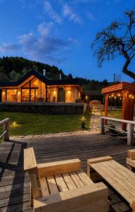 a wooden bench sitting in front of a house at Mountain villa in Skhidnitsa